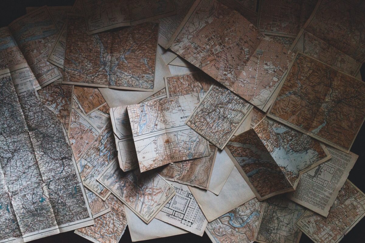 Old maps arrayed on a desk