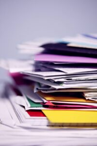 Stack of files and folders showing why you need to Organize Your Financial Life